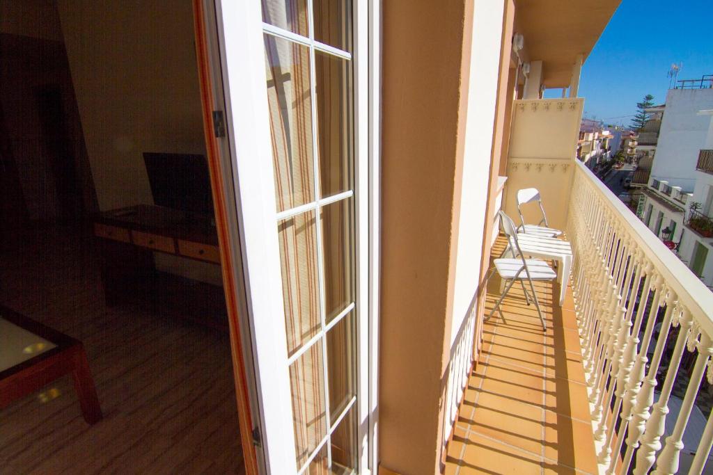 a balcony with a bench and a window at Apartamentos Jimmy in Nerja