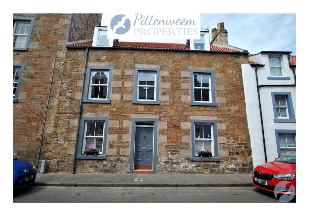 a brick building with a sign that reads fulham properties at Misty Morn- stunning home in East Neuk in Anstruther