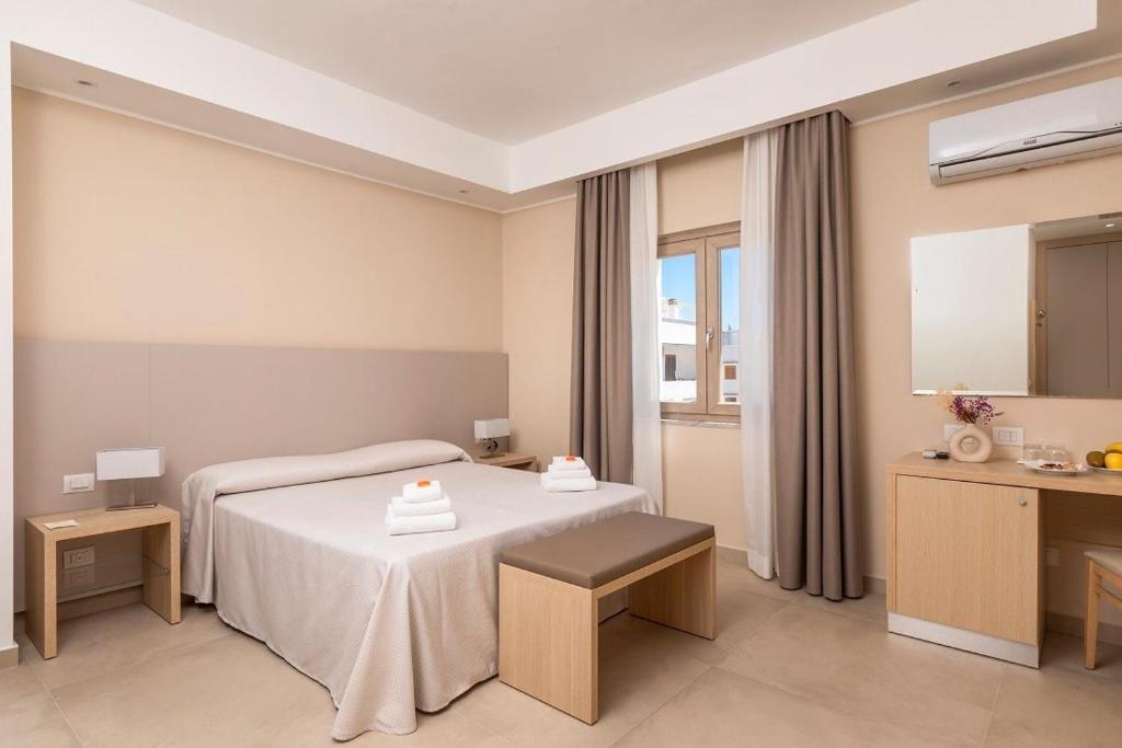 Postel nebo postele na pokoji v ubytování Hotel Degli Aranci