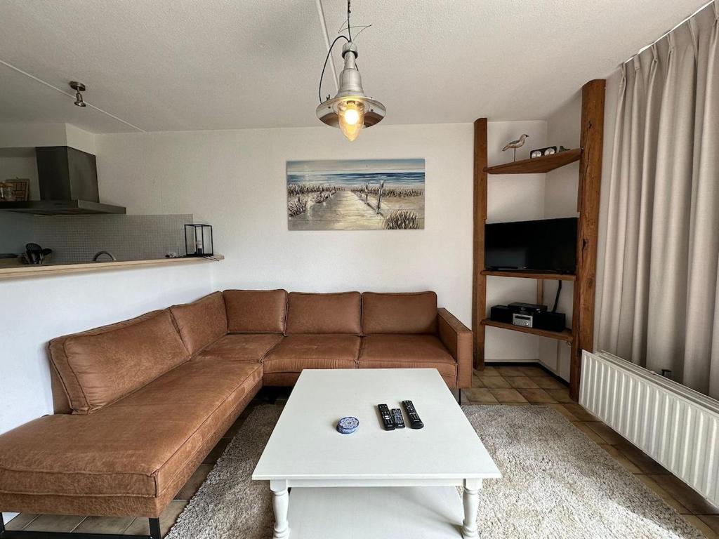 a living room with a couch and a coffee table at Heggerank 54 in Nieuwvliet