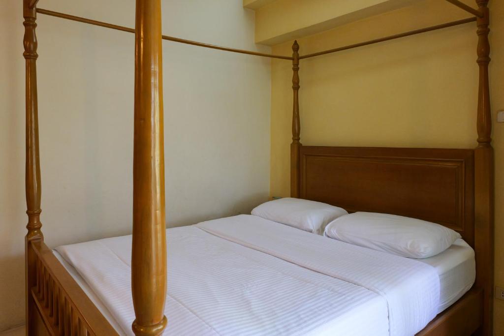 Postel nebo postele na pokoji v ubytování โรงแรมมูนแอนด์ซัน Moon and Sun Hotel