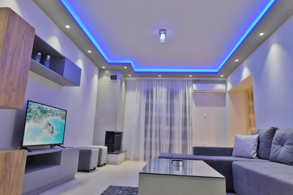 a living room with a blue led ceiling at Poli's Luxury suite @ N. Moudania in Nea Moudania