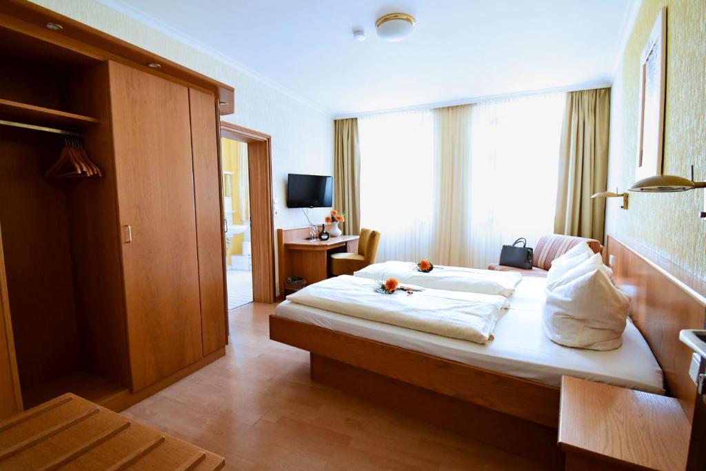 Postel nebo postele na pokoji v ubytování AKZENT Hotel Grüner Baum