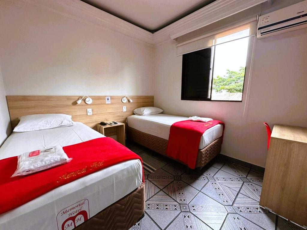a hotel room with two beds and a television at Memorial Hotel in São Paulo