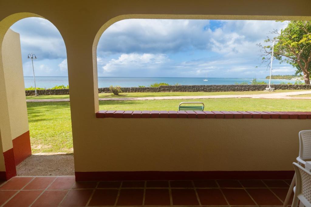 a view of the ocean from a room with a window at Crown Point Beach Hotel in Crown Point