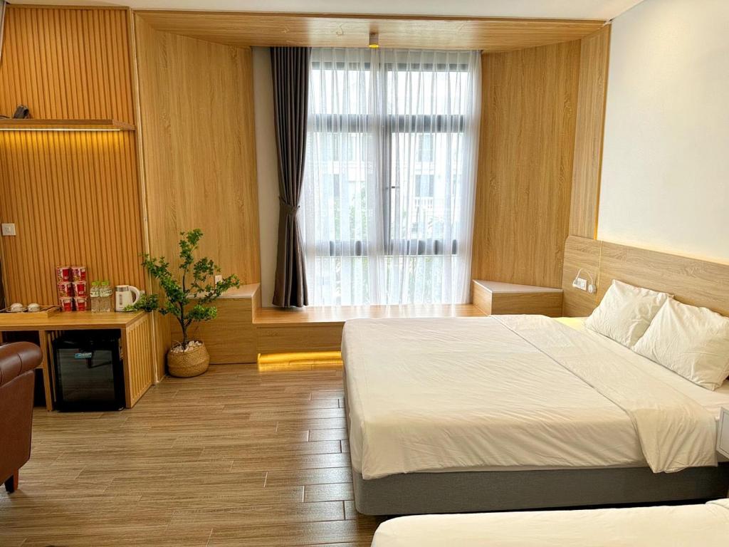 Postel nebo postele na pokoji v ubytování The Sol Homestay Grand World