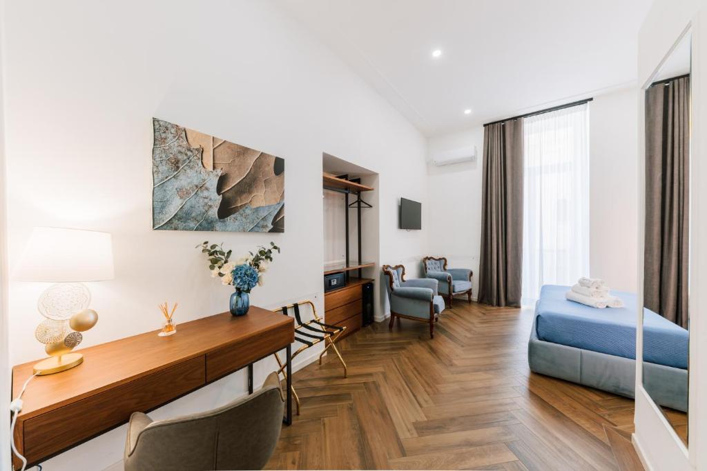 a bedroom with a bed and a desk in a room at Raggio di Sole in Maiori