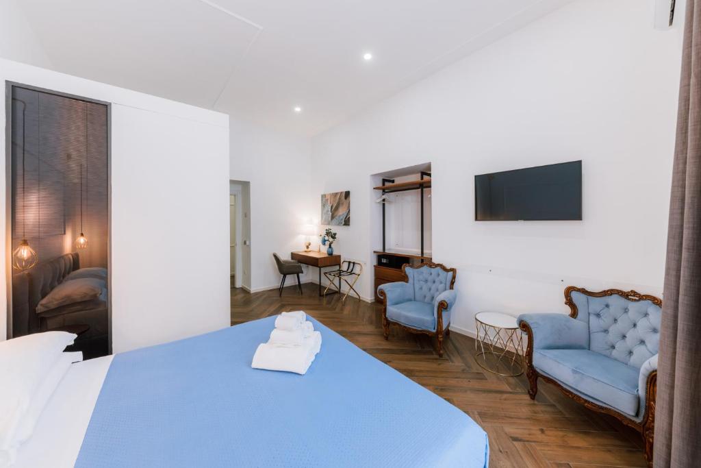 a room with a blue bed and a living room at Raggio di Sole in Maiori
