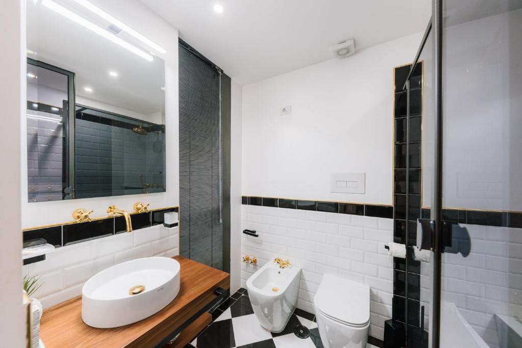 a bathroom with a white toilet and a sink at Raggio di Sole in Maiori