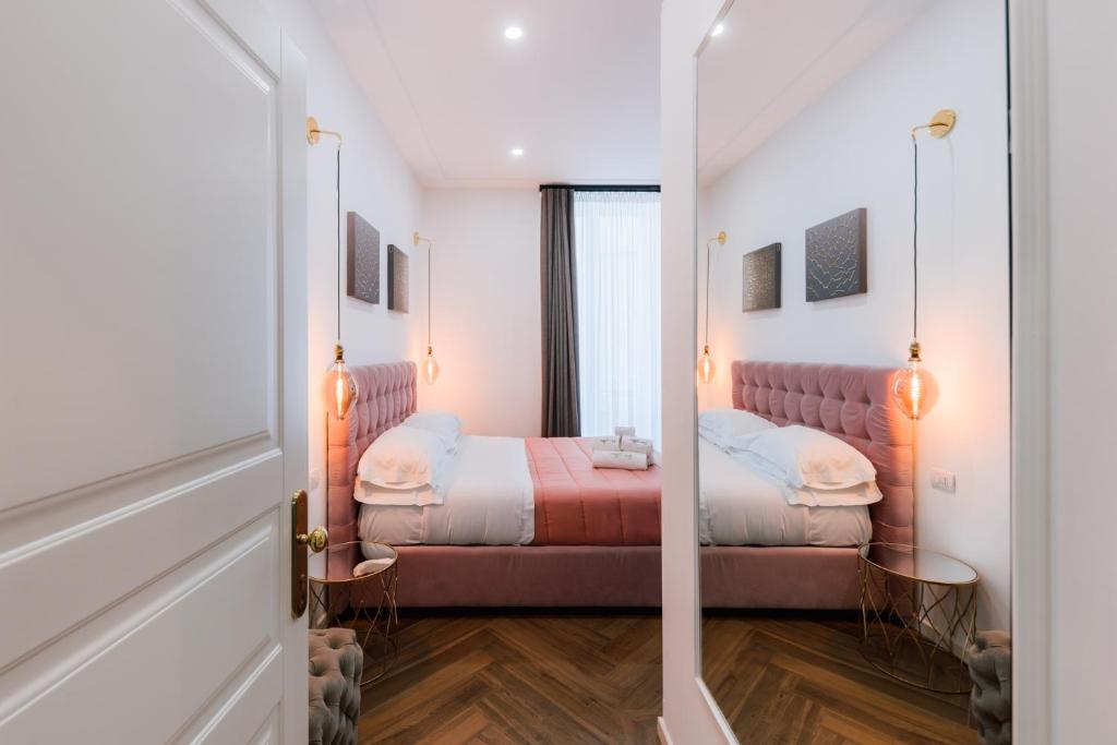 a bedroom with a bed and a mirror at Raggio di Sole in Maiori