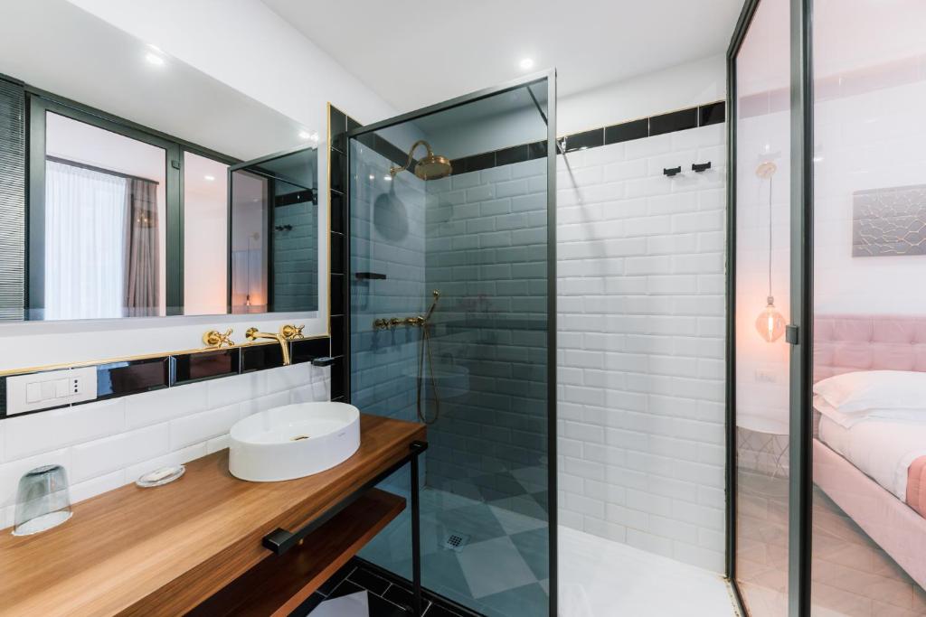 a bathroom with a glass shower and a sink at Raggio di Sole in Maiori