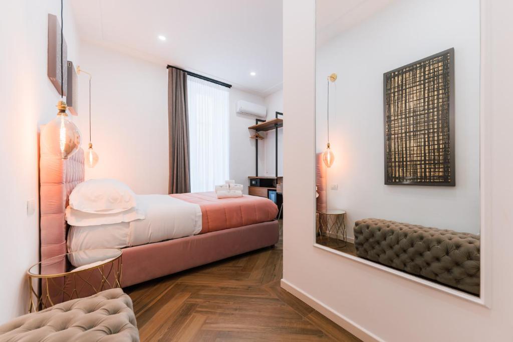 a bedroom with a bed and a mirror at Raggio di Sole in Maiori