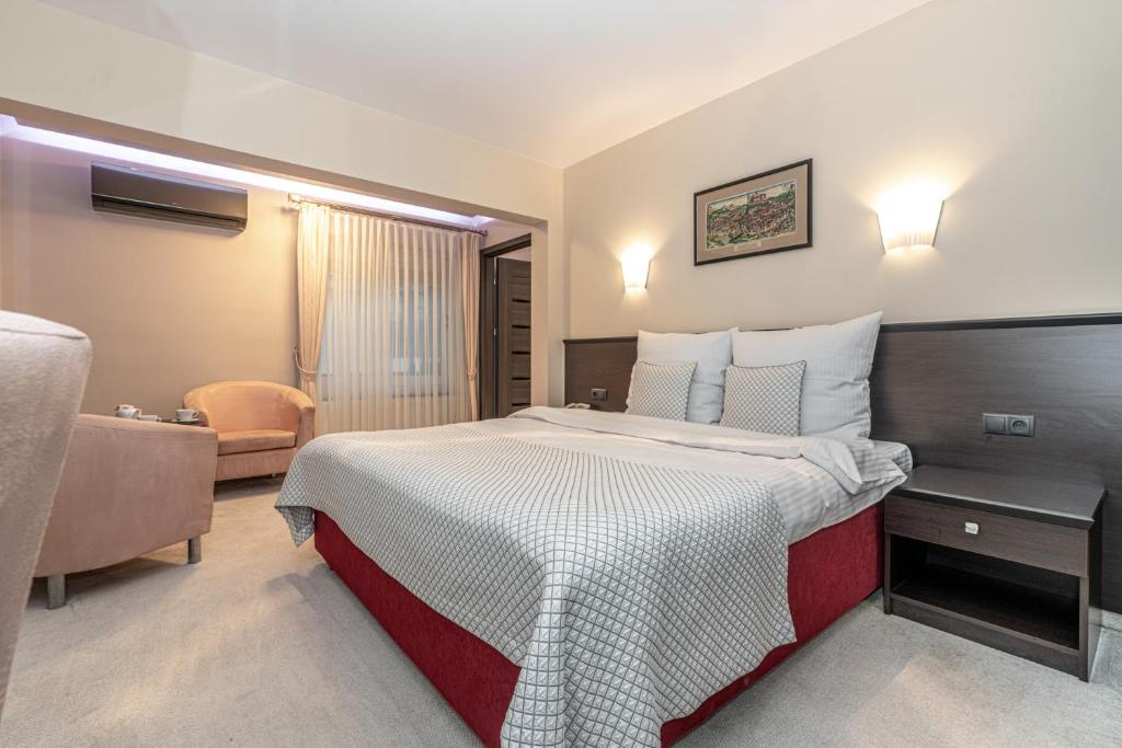 a hotel room with a bed and a chair at Hotel Soray in Wieliczka