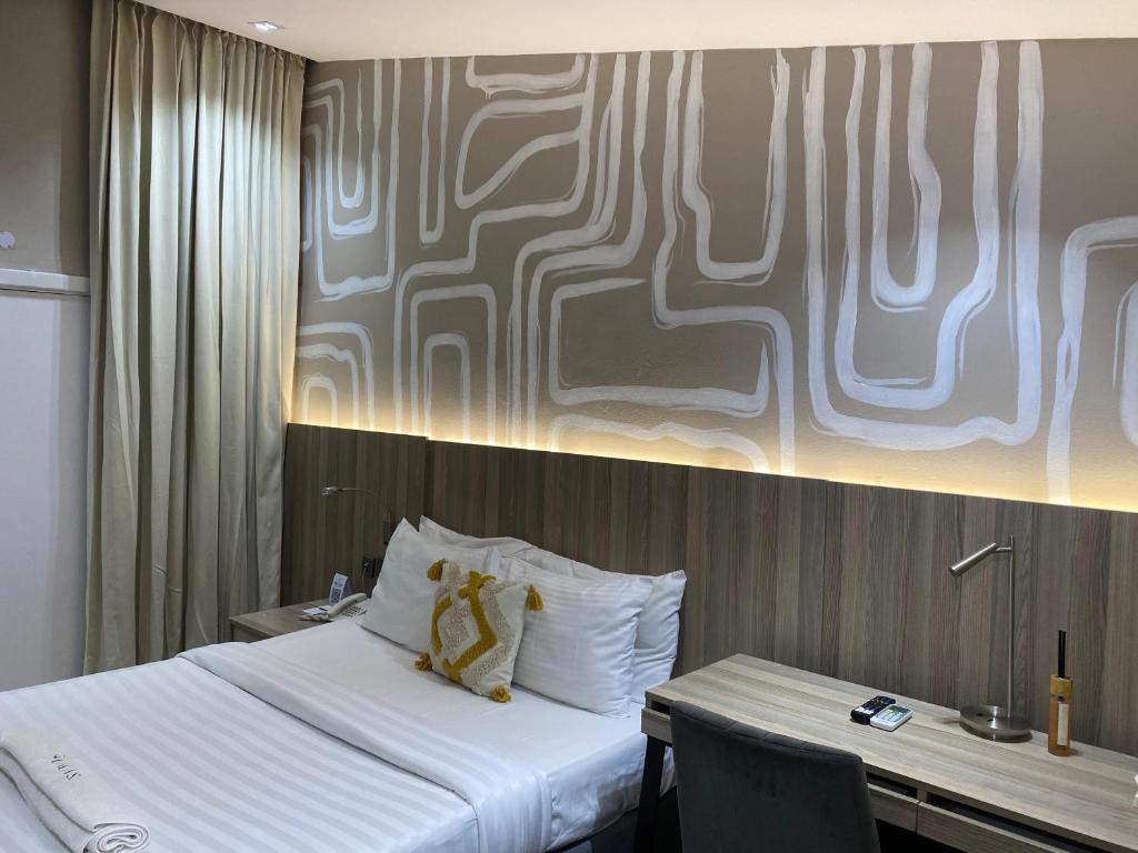 Postel nebo postele na pokoji v ubytování Lala's Boutique Hotel