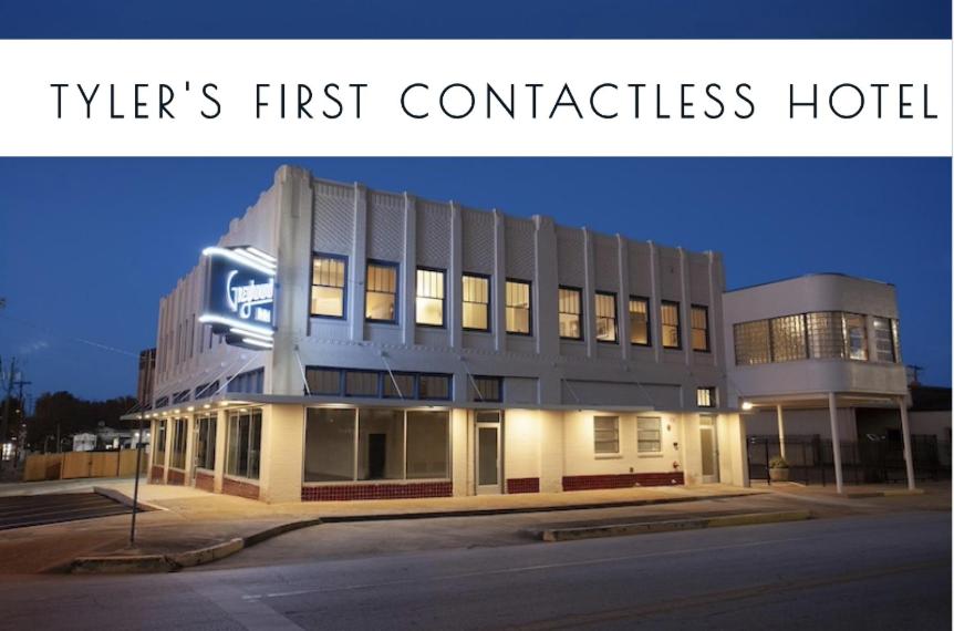 a building with the words tylers first commercial hotel at Greyhound Inn in Tyler