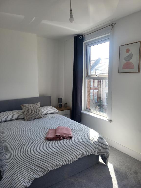 a bedroom with a bed and a window at Seaside 3 Bedroom Home in Ramsgate