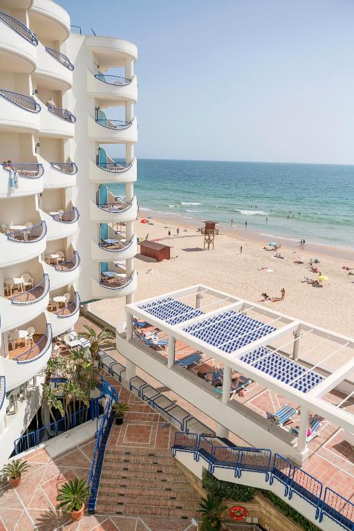 an aerial view of a hotel and the beach at Hotel Playa Victoria in Cádiz
