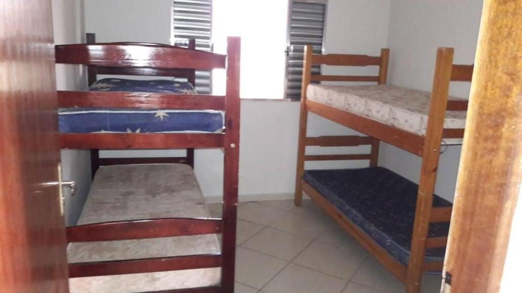 a room with three bunk beds and a window at Chácara Buíque&Xique in Jarinu