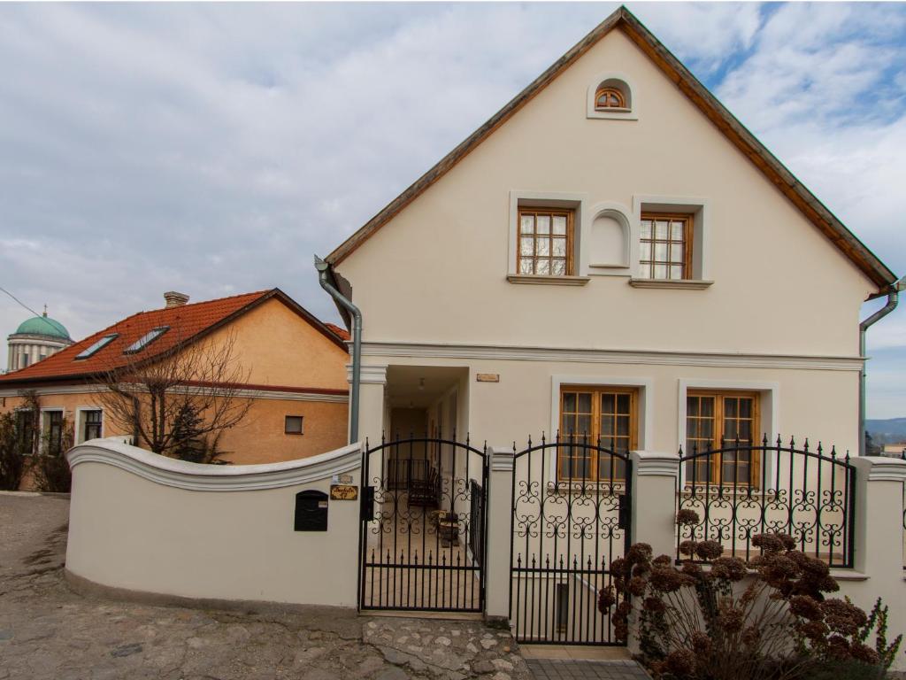 una casa blanca con una puerta negra en Amadeus Vendégház, en Esztergom