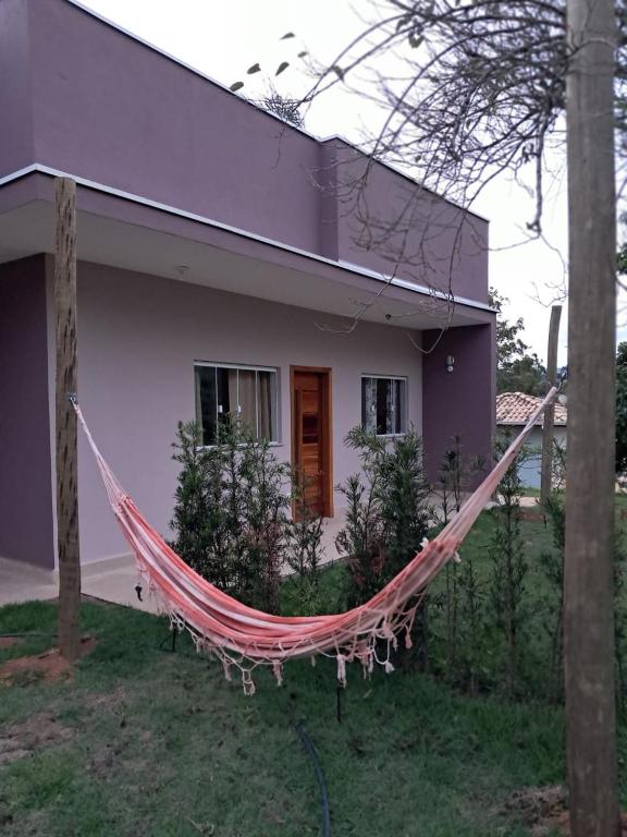 a hammock in front of a house at Recanto das Rosas in Extrema