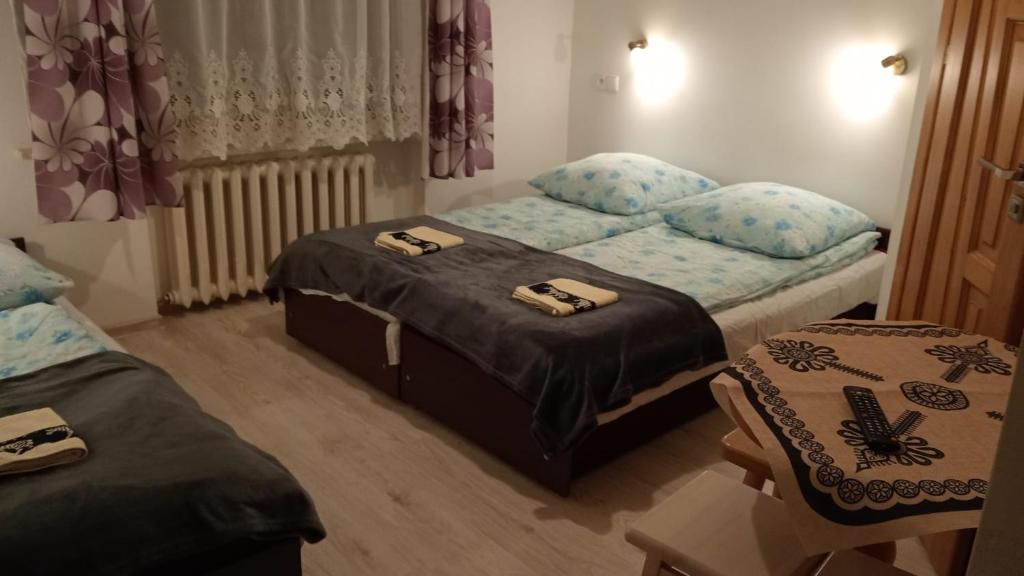 Posteľ alebo postele v izbe v ubytovaní Pokoje Gościnne U Babuni