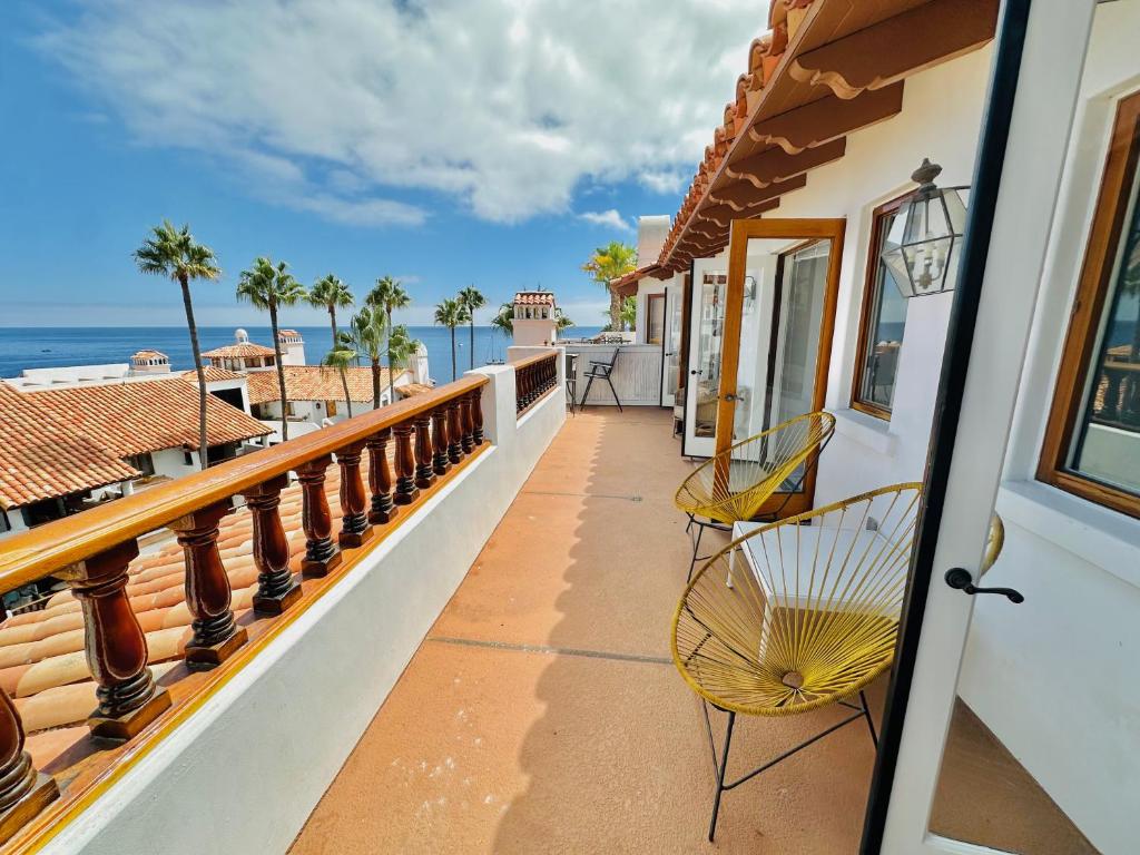 a balcony with chairs and a view of the ocean at Bright Avalon Villa W Ocean Views & Hot Tub in Avalon