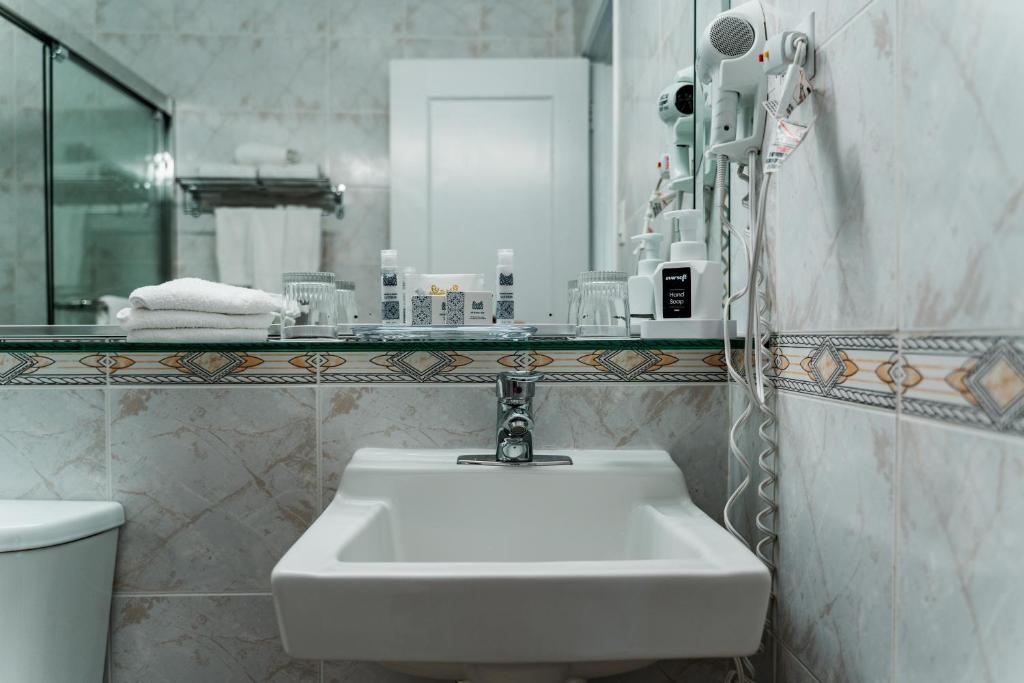 a bathroom with a white sink and a mirror at Congress Plaza Hotel Chicago in Chicago