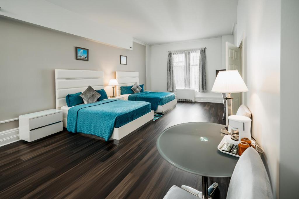 a hotel room with two beds and a table at Congress Plaza Hotel Chicago in Chicago