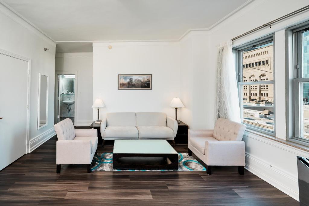 a living room with two chairs and a couch and a table at Congress Plaza Hotel Chicago in Chicago