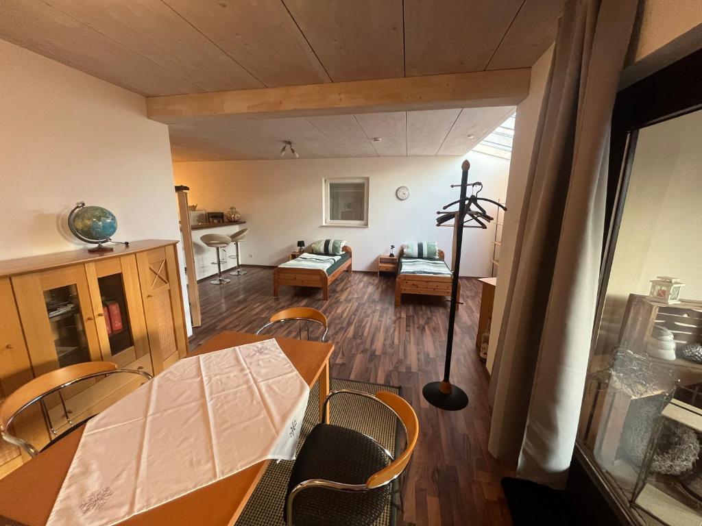 a room with a table and chairs and a living room at Monteurwohnung-Ferienwohnung Aalen Westhausen in Westhausen