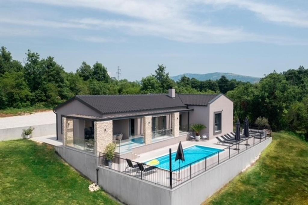 a house with a swimming pool in the backyard at Villa Anthea and Paola in Nedeščina