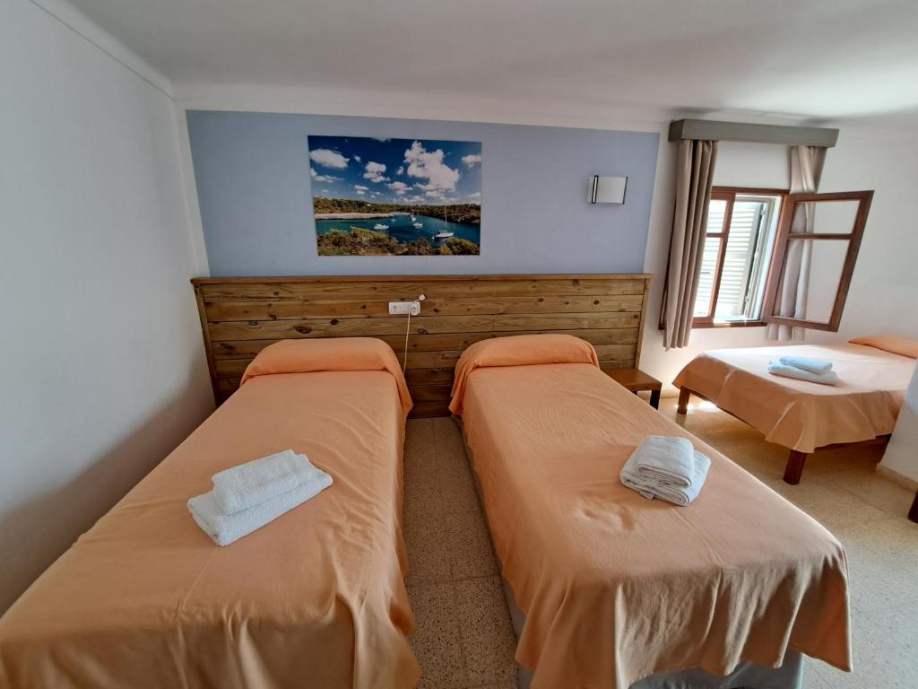 a bedroom with two beds in a room at Hostal Playa in Cala Santanyi