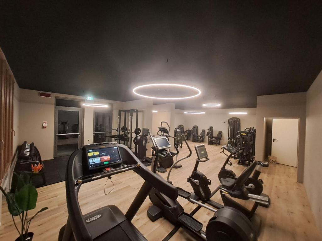a gym with a bunch of exercise bikes in a room at Hotel Alla Dolina in Sistiana