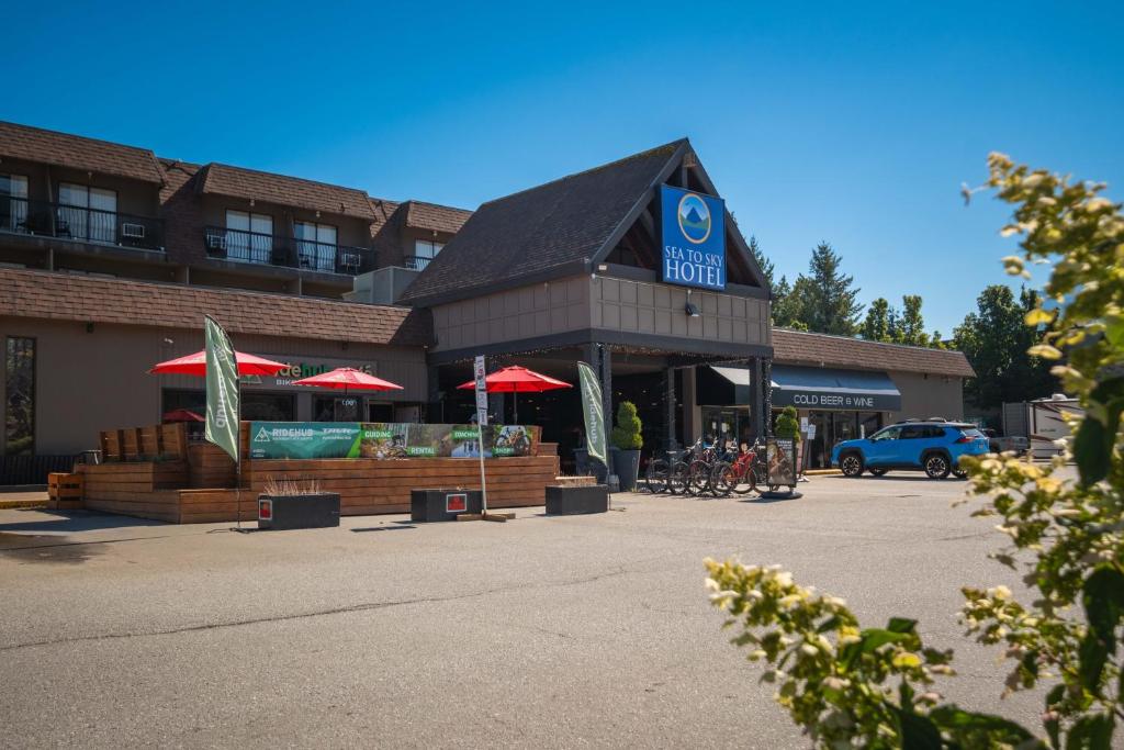 a store with red umbrellas in a parking lot at Sea to Sky Hotel and Conference Centre in Squamish