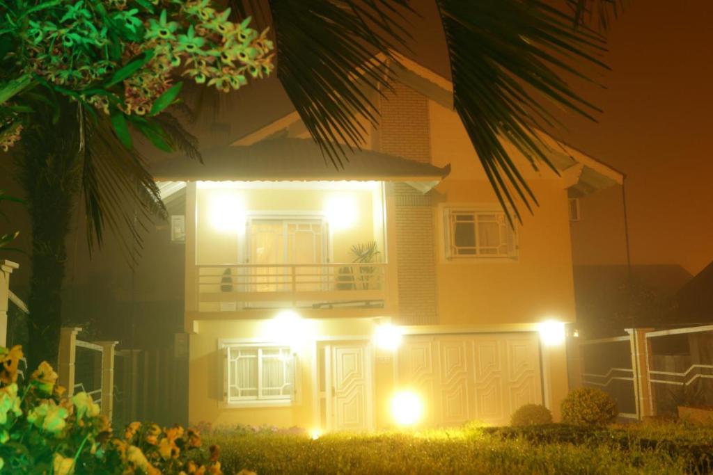 a house with lights on the front of it at night at Casa da Fabi in Gramado