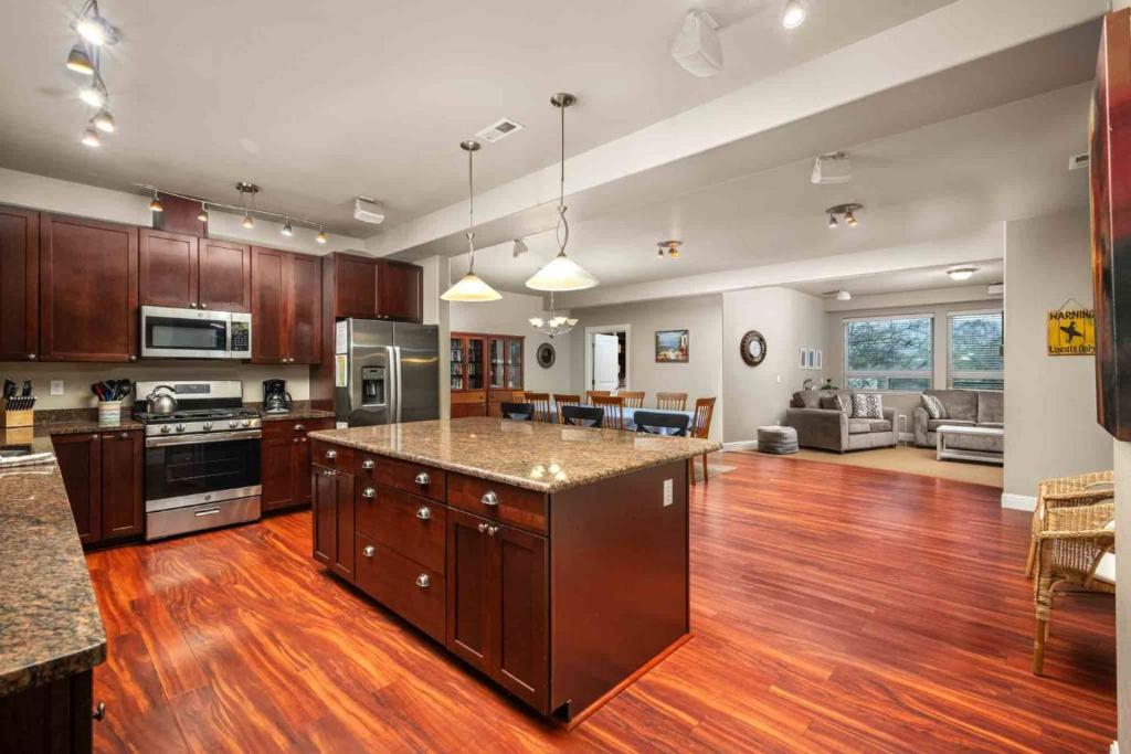 a large kitchen with wooden floors and a large island in it at Beach Mode in Seaside