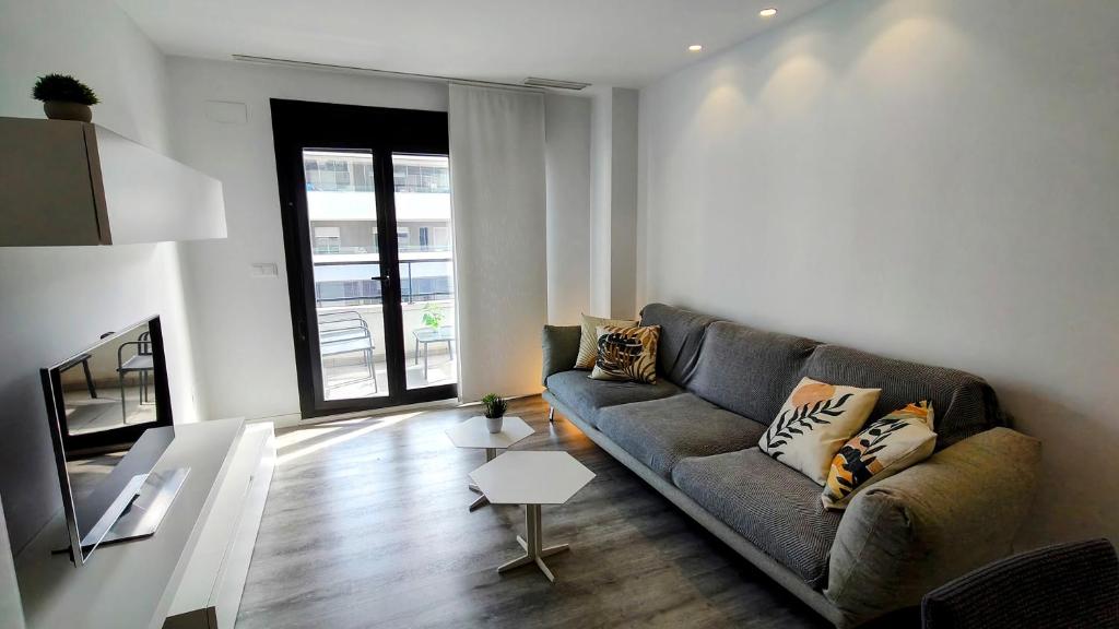 a living room with a couch and a table at Vinalopó apartment con parking in Elche