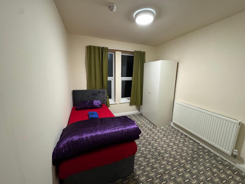 a small room with a bed and a window at Barnsley Guesthouse in Barnsley