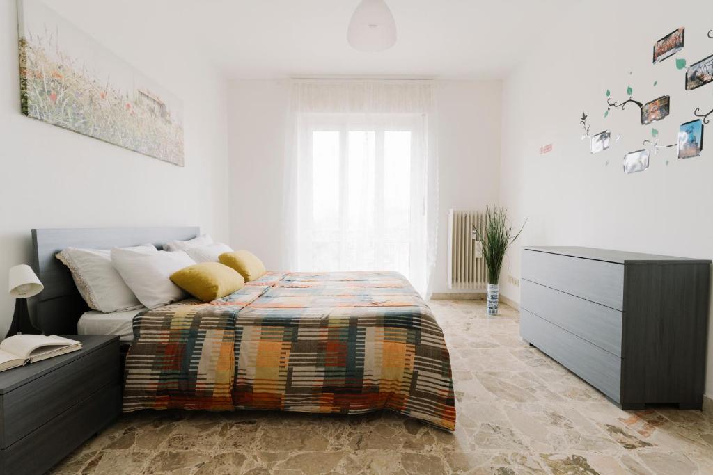 a bedroom with a bed and a dresser in it at Colombo Center Welcome A&A in Santhià