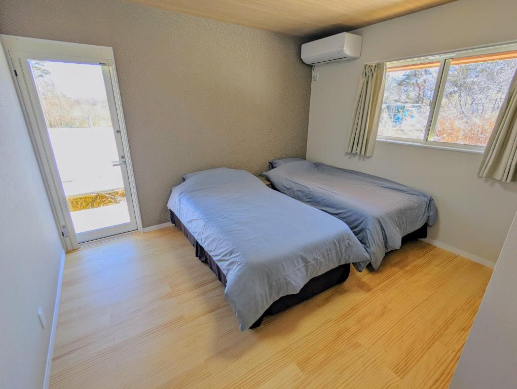 Postel nebo postele na pokoji v ubytování Asuka Resort 富士山中湖