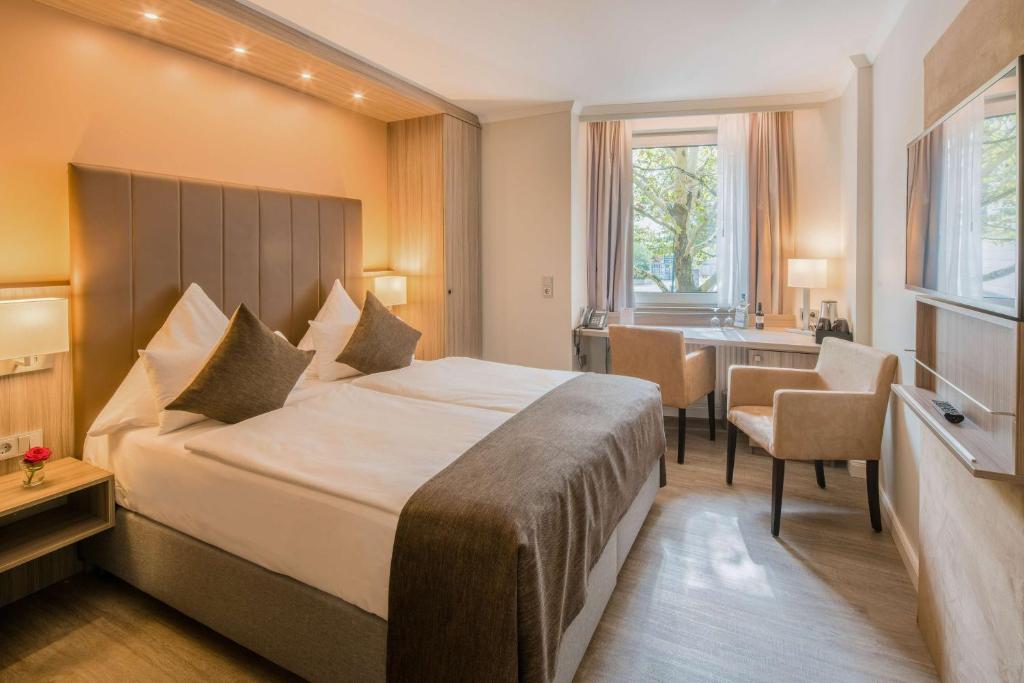 Postel nebo postele na pokoji v ubytování Best Western Plus Hotel Regence