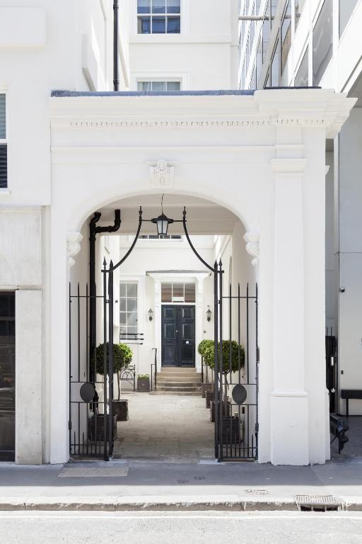 Hotel Bank Serviced Apartments by LovelyStay, an entrance to a white building with a black door at Bank Serviced Apartments by LovelyStay in London