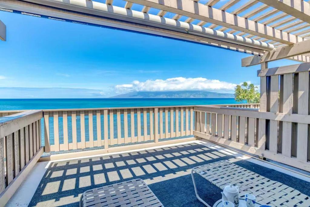a balcony with a view of the ocean at A9 Direct Oceanfront 2 Level 2 Lanai Amazing Views Sunsets & AC Comfort in Lahaina