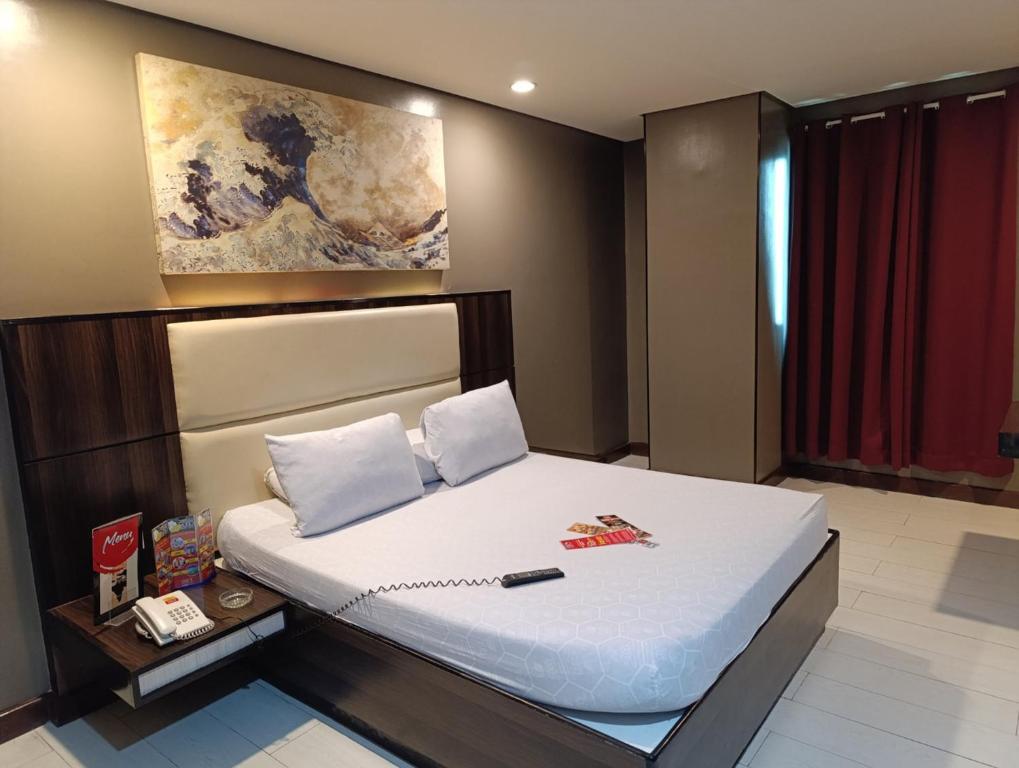 Postel nebo postele na pokoji v ubytování Hotel Sogo Malate