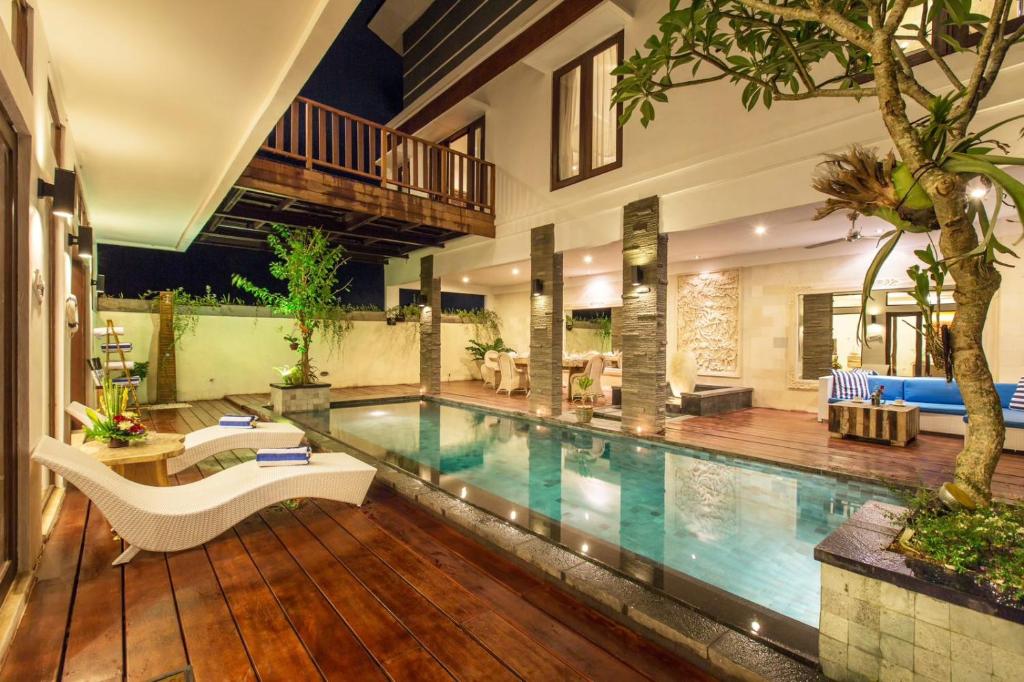 a swimming pool in a house with a house at Dragonville 3BR Private Pool Canggu Residence CYN in Mantaak