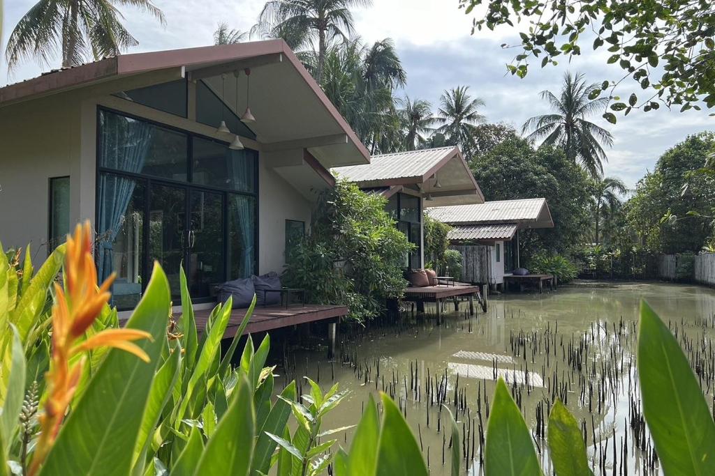 a house in the middle of a flooded street at Kalacanal resort in Ban Bang Khan Taek (1)
