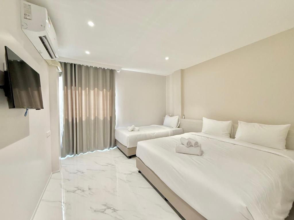 Postel nebo postele na pokoji v ubytování โรงแรมแรบบิท Rabbit Hotel Nangrong