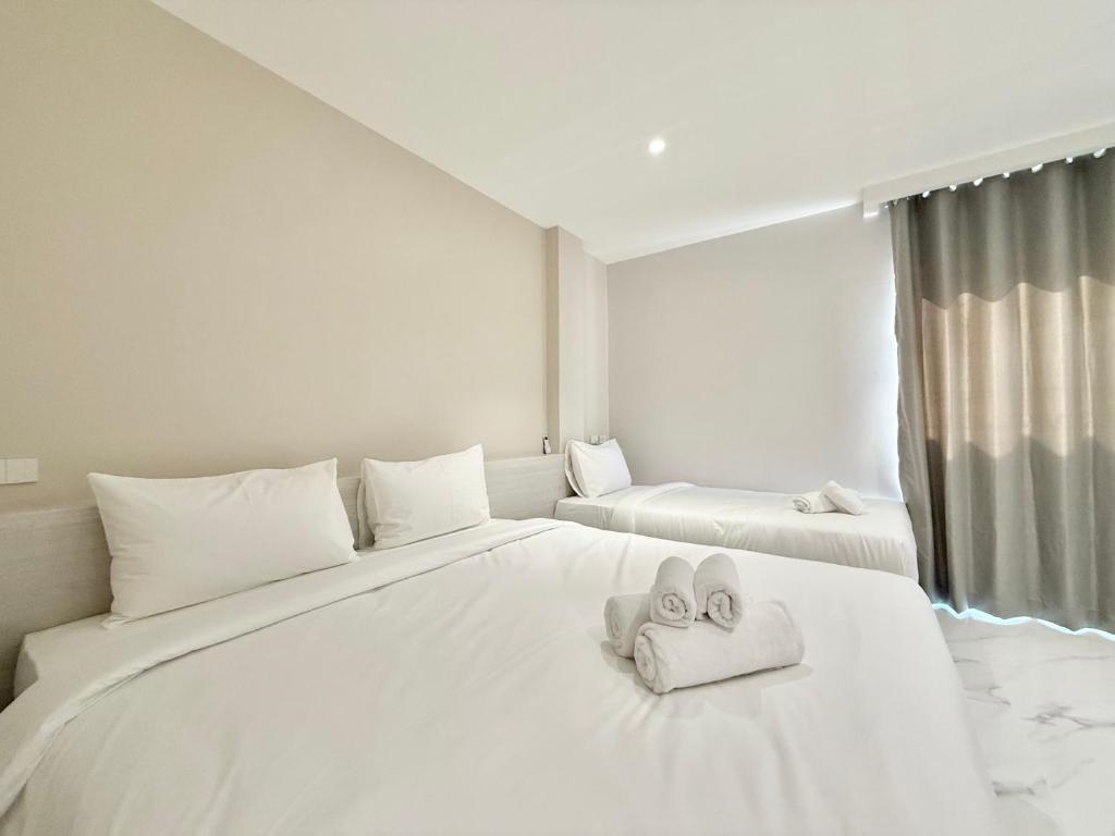 Postel nebo postele na pokoji v ubytování โรงแรมแรบบิท Rabbit Hotel Nangrong