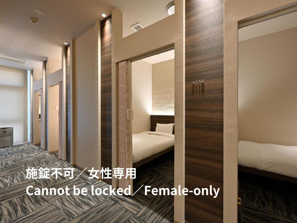 Postel nebo postele na pokoji v ubytování UNO HOTEL