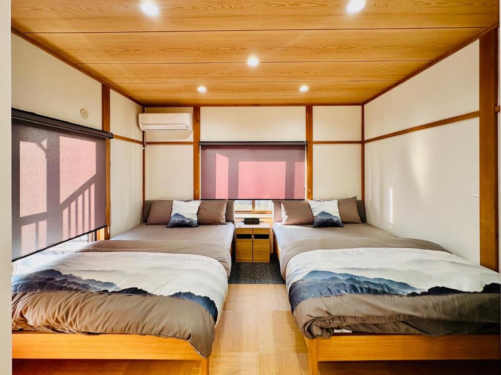 Postel nebo postele na pokoji v ubytování 加美屋リゾート 秩父 庭日和-Kamiya Resort Chichibu Niwabiyori
